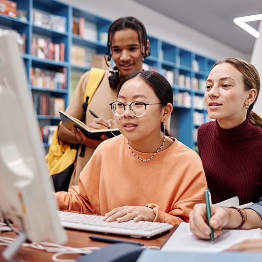 Media Literacy group of teens reviewing news on a computer
